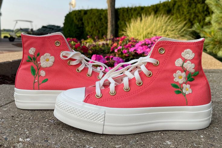 Women's size 7.5 Platform Converse shoes. Color is listed as Watermelon slush. Embroidery is done by hand and features white flowers Spring High-top Hand Painted Sneakers, Spring Hand Painted Round Toe Sneakers, Spring Hand-painted High-top Sneakers, Hand Painted Pink Sneakers For Spring, Handmade Low-top Sneakers For Spring, Handmade Low-top Spring Sneakers, Casual Sneakers With Floral Applique For Spring, Spring Casual Sneakers With Floral Applique, Casual Floral Applique Sneakers For Spring