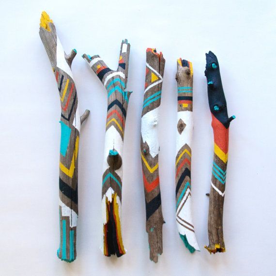 four different types of toothbrushes are lined up on a white surface, one is made from wood and the other is painted with multicolored fabric