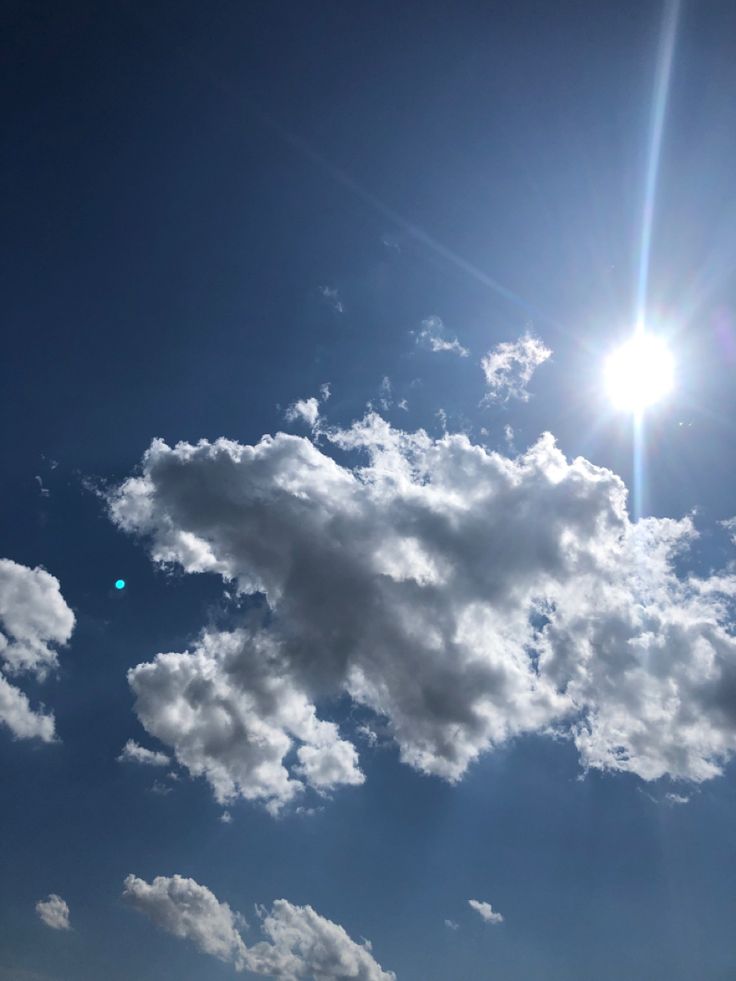 the sun shines brightly in front of some clouds