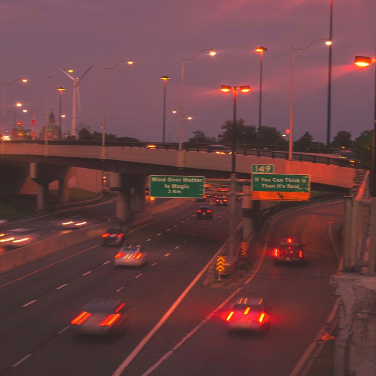 cars are driving down the highway at night