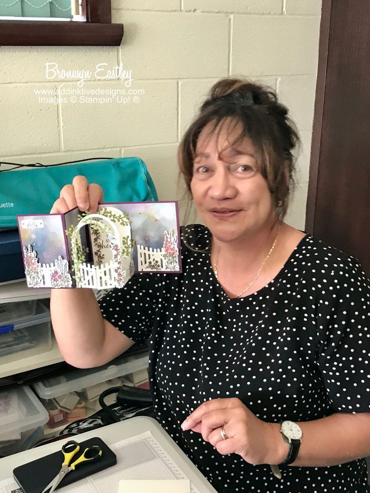 a woman holding up a card in front of her face