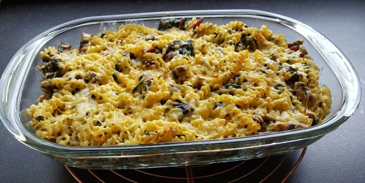 a casserole dish filled with pasta and vegetables on top of an oven rack