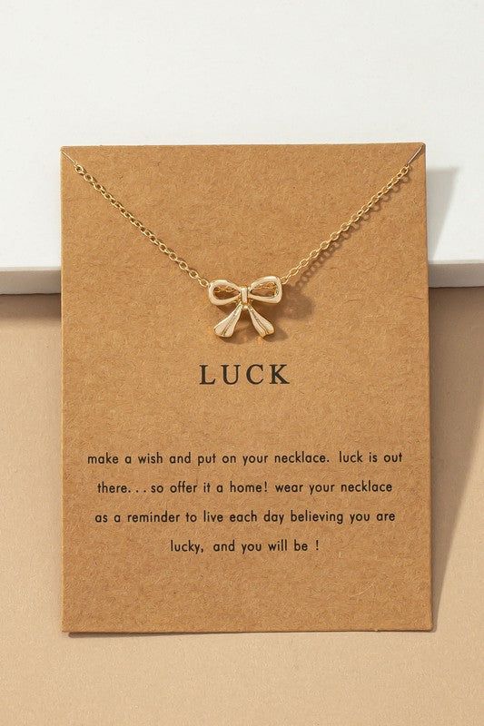 Bow Charm Necklace Because everyday is a gift! This style makes a great gift idea for yourself or someone else. Wear it on its own, or layer it with other necklaces. Fit: Adjustable-Size: 18" + 3" extender Closure: Clasp Comes on brown Luck Card Adjustable Collar Necklace Jewelry As Gift, Adjustable Clavicle Chain Jewelry For Gift, Adjustable Clavicle Chain Jewelry As A Gift, Elegant Brown Jewelry With Adjustable Chain, Adjustable Clavicle Chain Charm Necklaces For Gift, Delicate Pendant Necklace For Birthday, Adjustable Necklace For Gifts, Adjustable Necklace For Gift Occasions, Minimalist Necklace For Birthday Gift