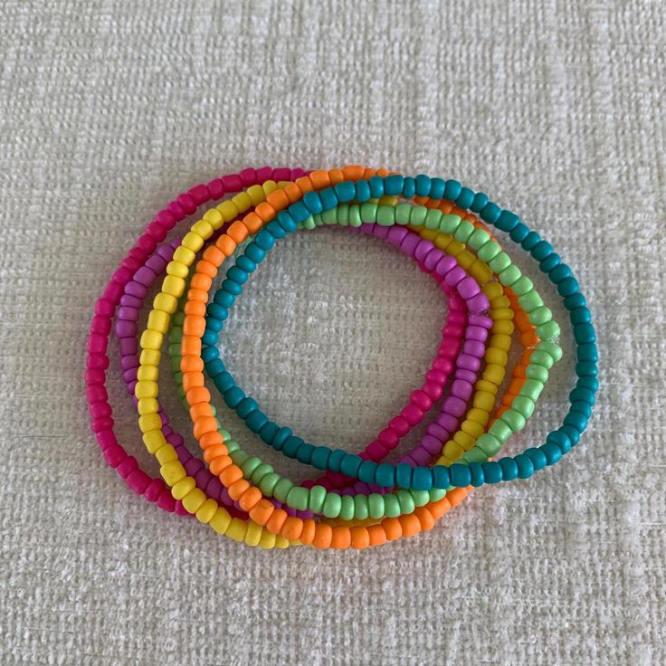 Six stackable bracelets in tropical colors, perfect for Summer! Vibrant Round Beads Bracelets For Beach, Colorful Beach Bracelets With Round Beads, Trendy Rainbow Beaded Bracelets For Beach, Trendy Stackable Beaded Bracelets For Beach, Summer Stackable Stretch Bracelet, Beachy Multicolor Bracelet With Round Beads, Stackable Stretch Bracelet For Summer, Trendy Stackable Summer Bracelets, Playful Colorful Bracelets For The Beach