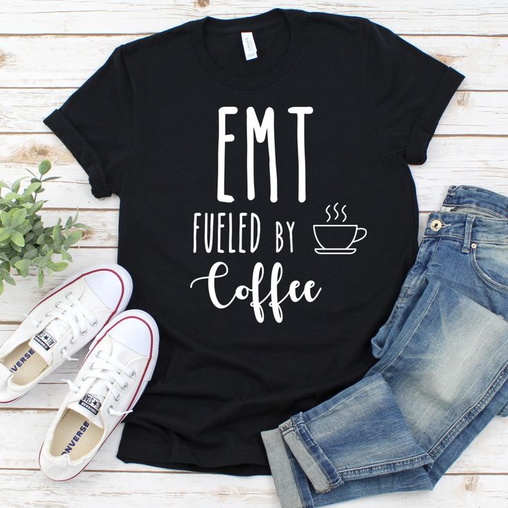 a t - shirt that says emt fueled by coffee next to jeans and sneakers