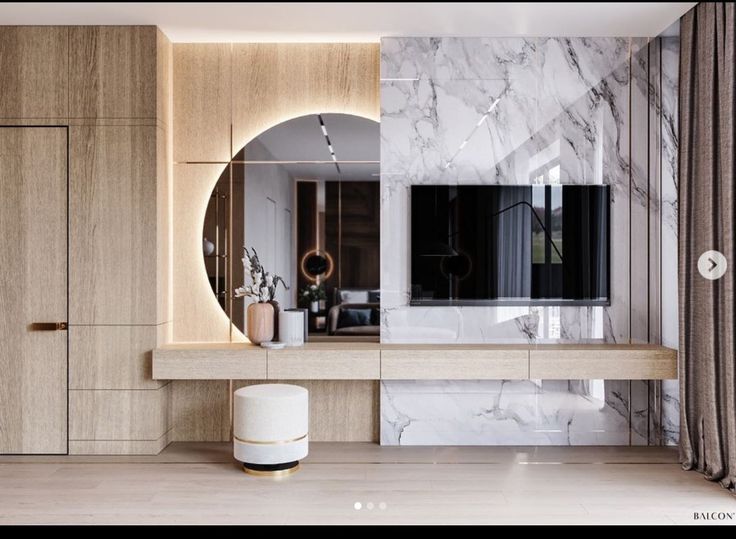 a bathroom with marble walls and flooring next to a large mirror on the wall