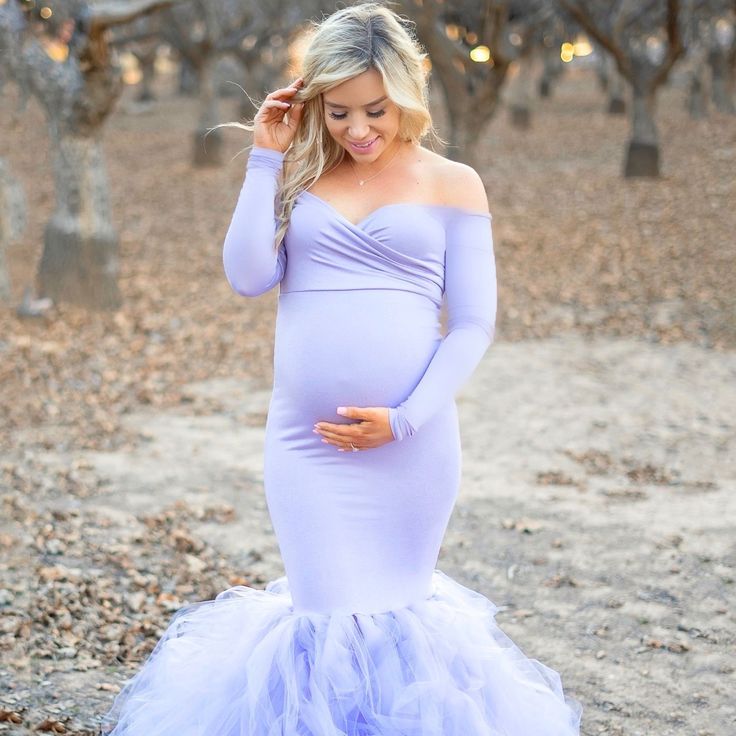 Our Off-the-Shoulder Sweetheart Tulle Gown is like stepping into a movie! A long sleeve princess maternity gown, constructed of premium stretch material on the bodice with a handcrafted tulle bottom. This gown is pure elegance and is perfect for your maternity photoshoot or special occasion.  Pictured in Lavender.  #SexyMamaMaternity #maternitygown #photoshootgown #maternitypictures Long Sleeve Tulle Ball Gown With Fitted Bodice, Long Sleeve Ball Gown With Fitted Bodice, Fitted Tulle Gown With Long Sleeves, Fitted Long Sleeve Tulle Gown, Fitted Floor-length Tulle Maternity Dress, Long Sleeve Maternity Dress For Wedding, Long Sleeve Tulle Maternity Wedding Dress, Maternity Tulle Gown With Long Sleeves, Maternity Long Sleeve Tulle Gown