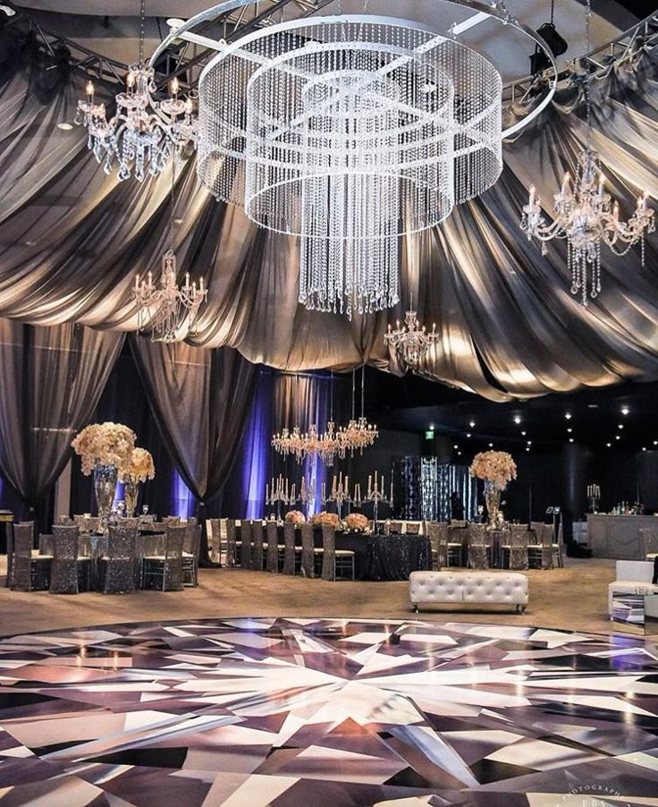 an elegant ballroom with chandeliers and tables