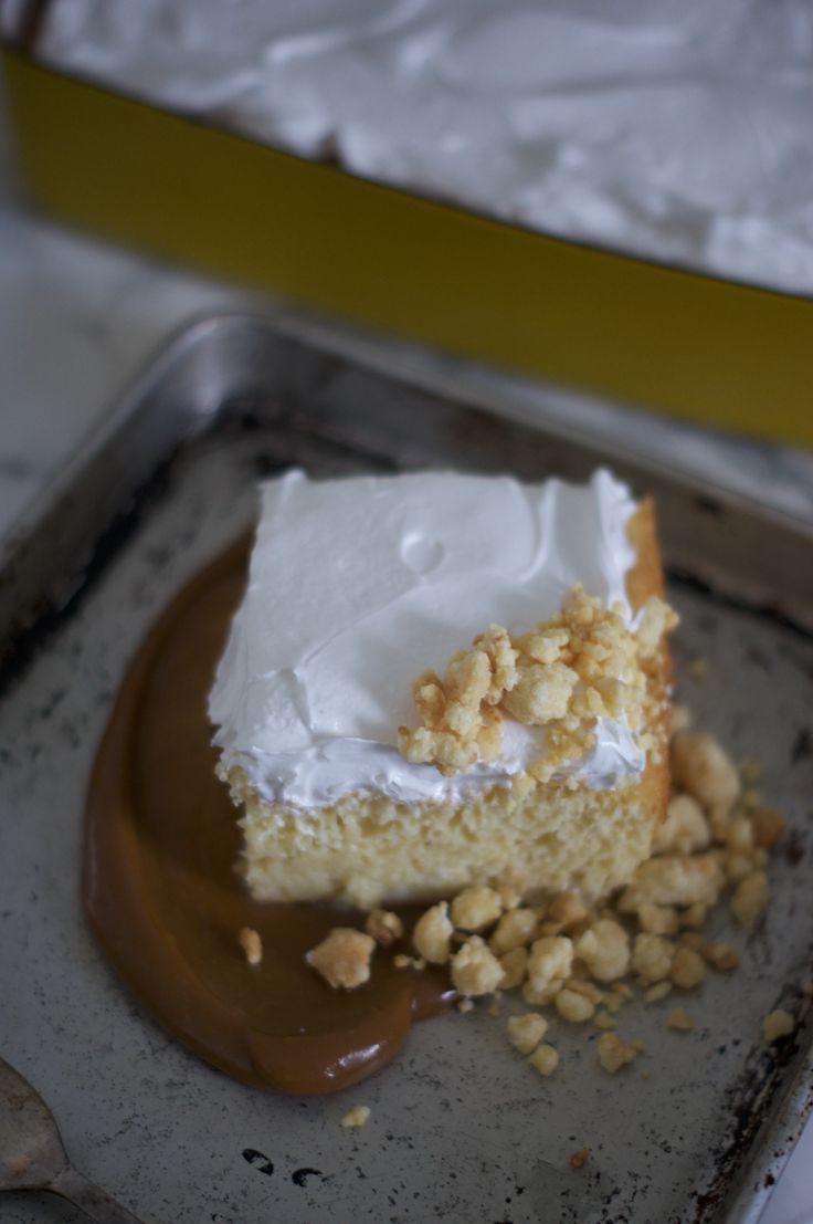 a piece of cake sitting on top of a pan covered in frosting