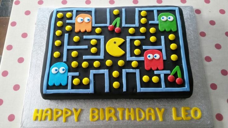 a birthday cake with an image of pacman and friends on the front, along with words happy birthday leo