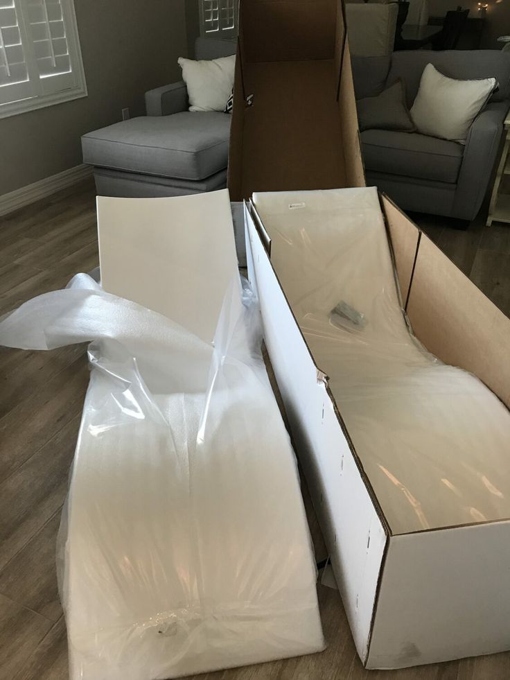 two boxes are stacked on top of each other in the middle of a living room