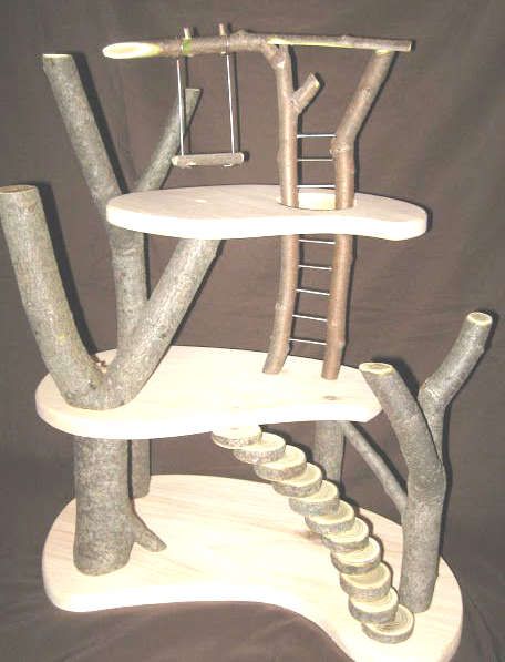 a tree house made out of concrete and wood with ladders to the top, sitting on a white surface