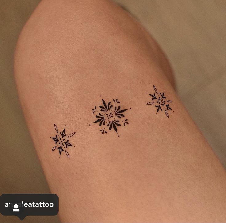 a woman's thigh with three snowflakes on it