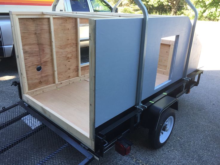 the back end of a small trailer with its doors open