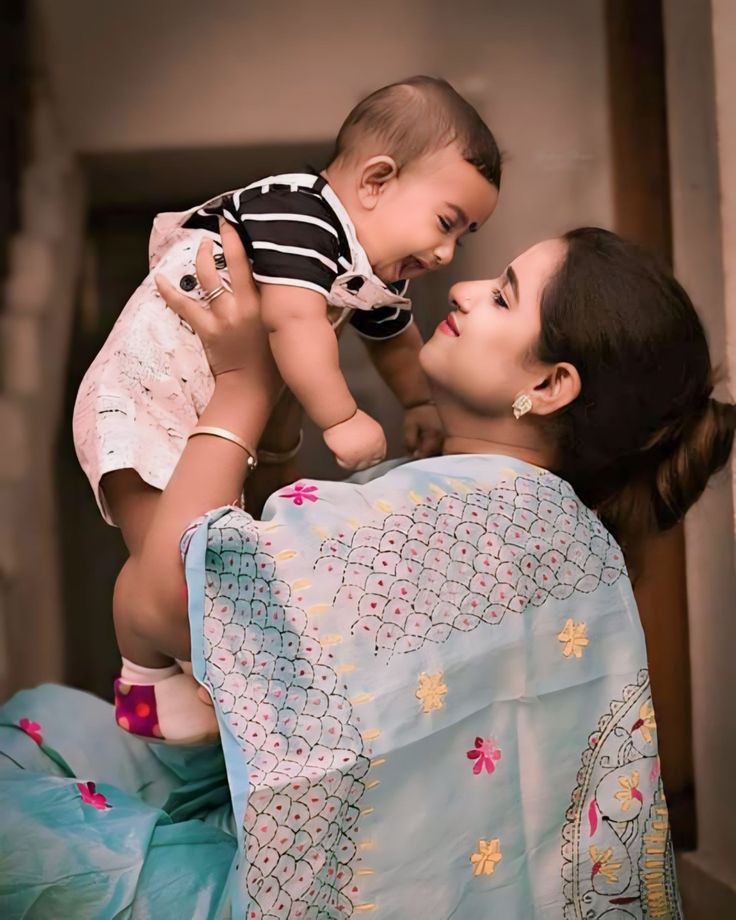 a woman holding a baby in her arms