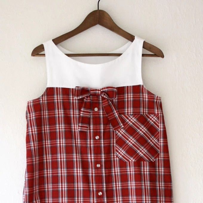 a red and white plaid shirt hanging on a hanger