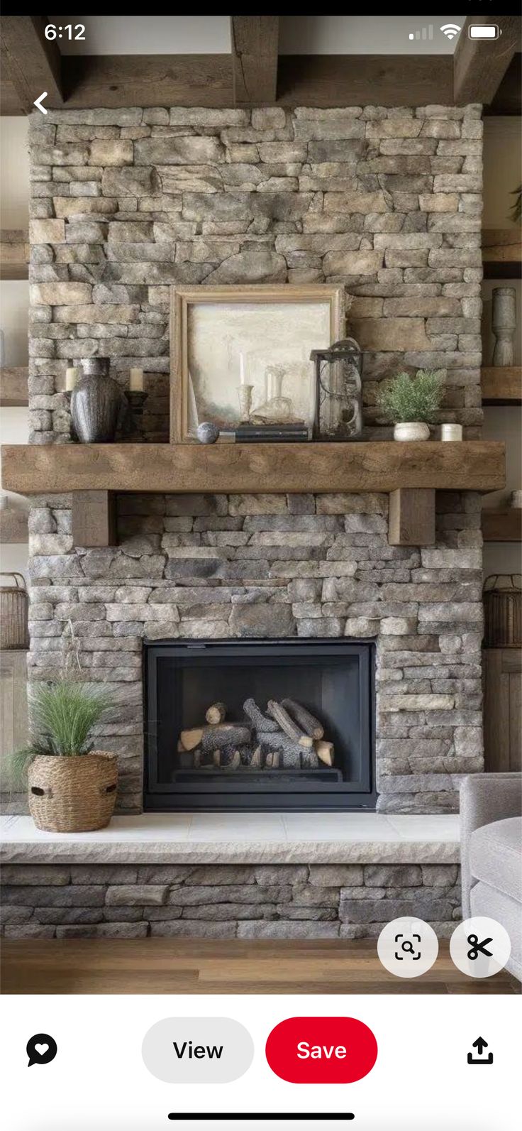 an image of a living room with stone fireplace and built - in shelving unit