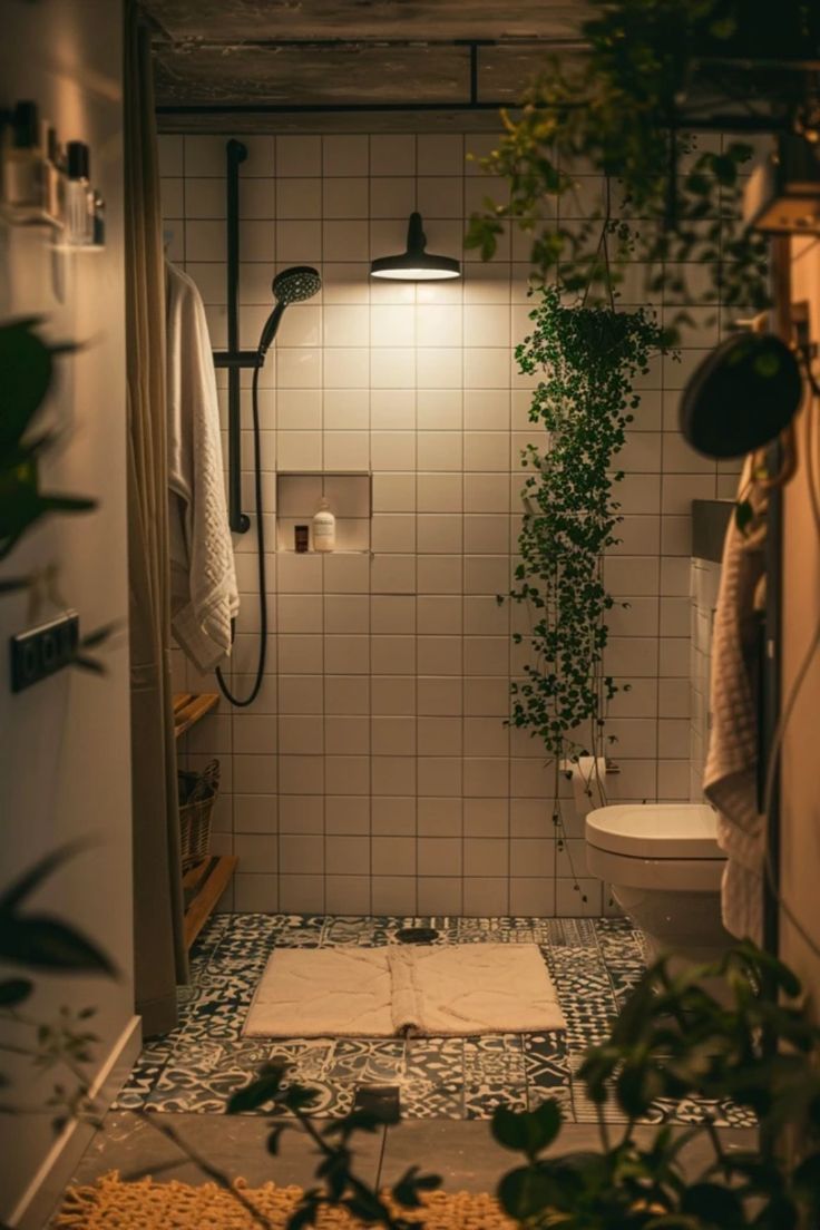 a bathroom with plants growing on the wall and tiled floor, along with a shower