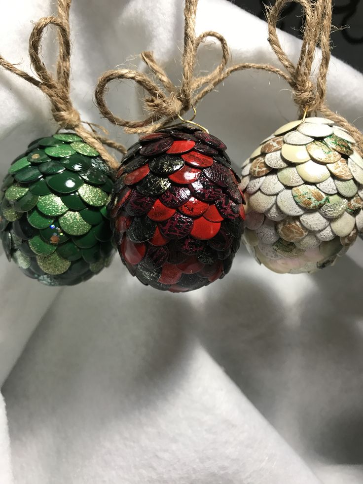 three glass ornaments hanging from twine with jumbo balls attached to each ornament