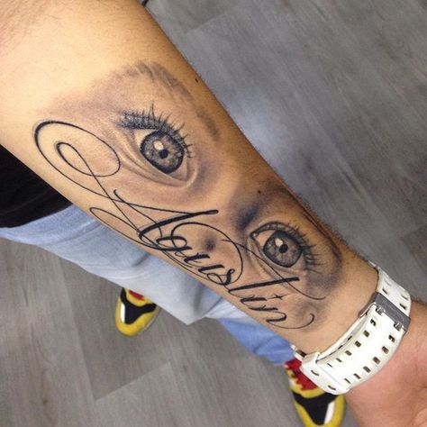 a man's arm with an eye tattoo on it