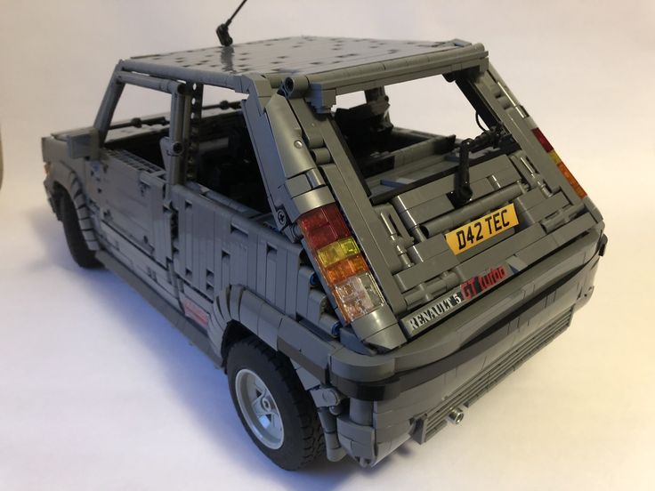 a toy car made out of legos on a white surface