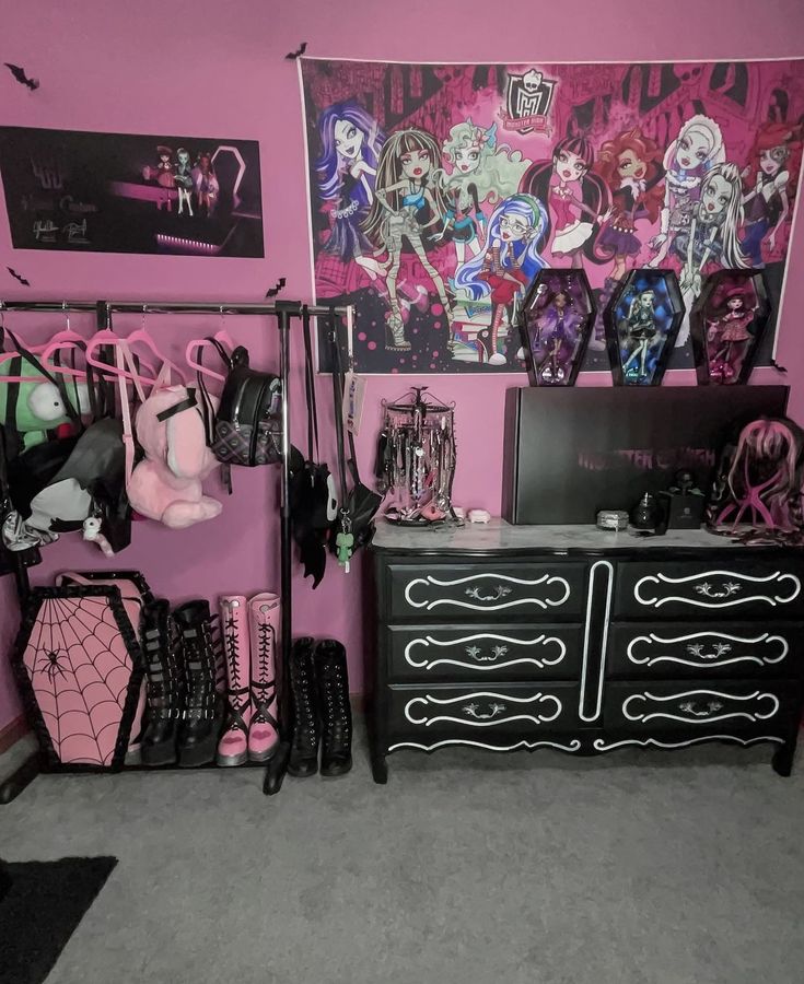 a room with pink walls, black furniture and monster dolls on the wall above it