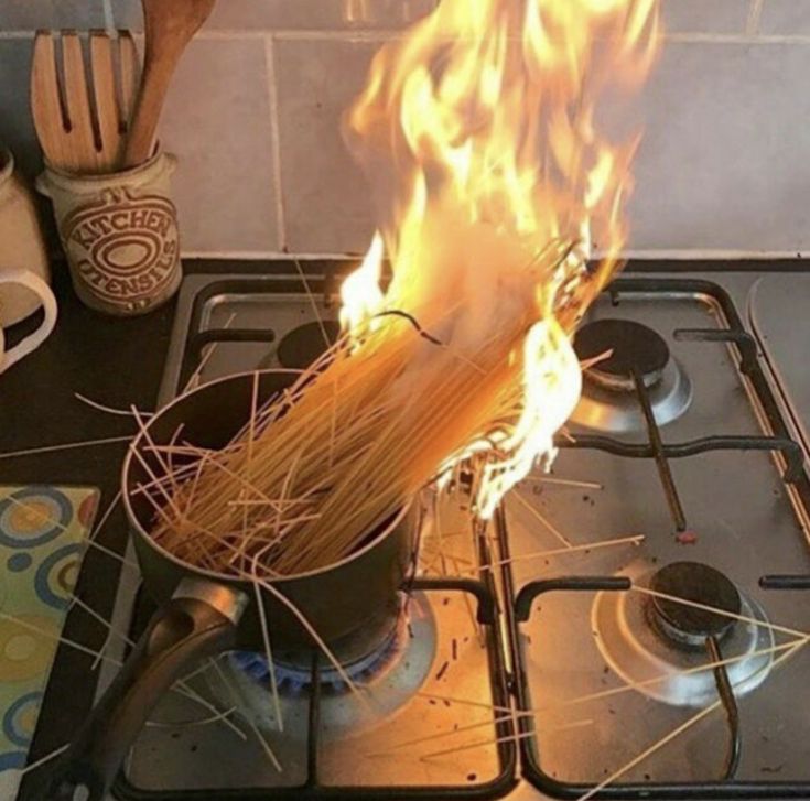 a pot on top of a stove with some spaghetti in it's burners