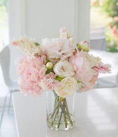 a vase filled with pink and white flowers