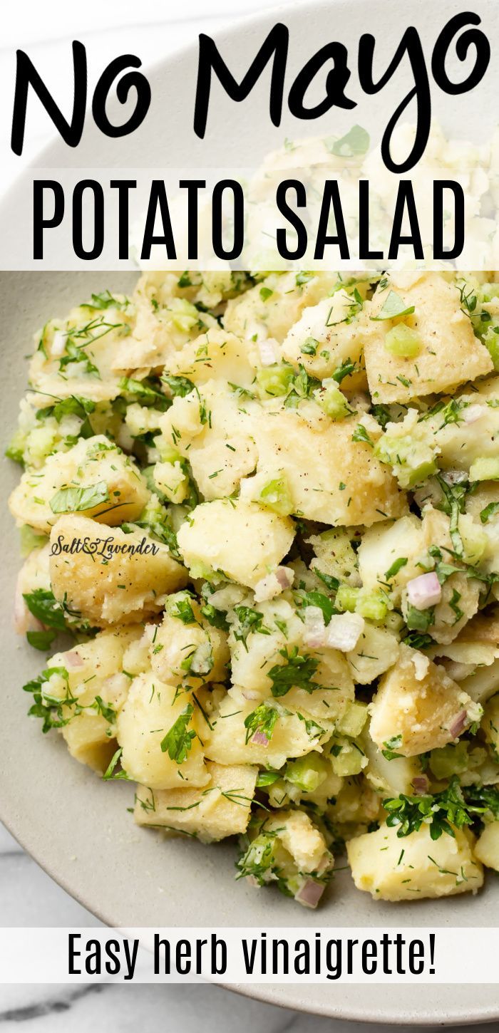 a white plate topped with potato salad on top of a table