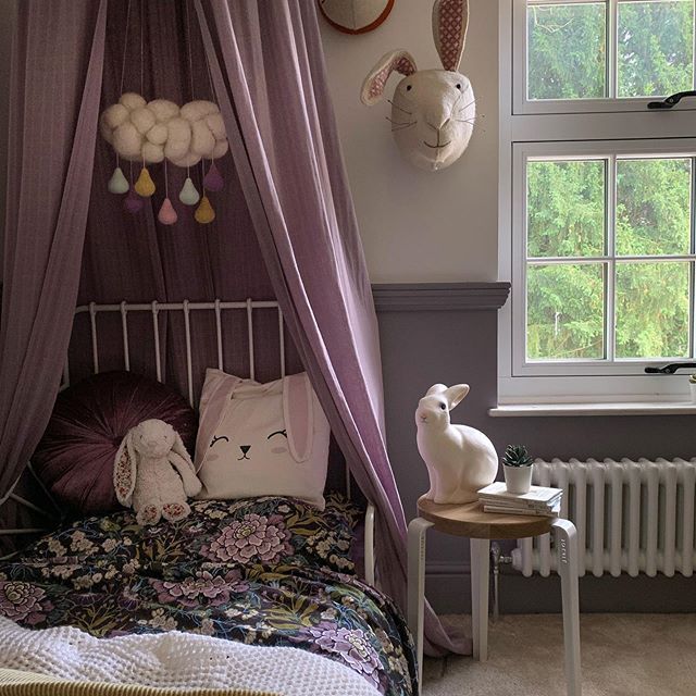 an instagram photo of a bedroom with purple curtains