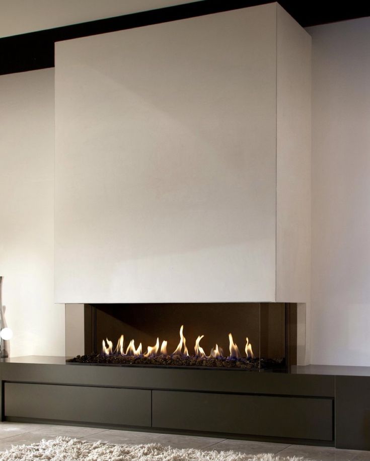 a modern fireplace is shown in the middle of a room with white walls and carpet