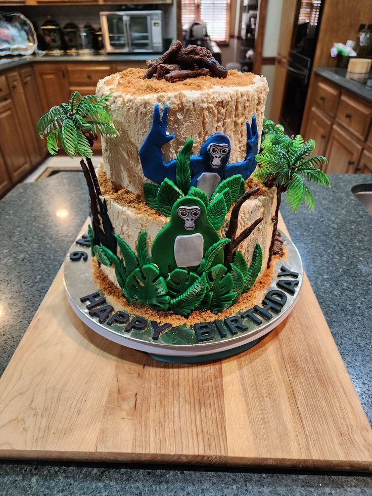 a decorated cake sitting on top of a wooden table next to a kitchen countertop