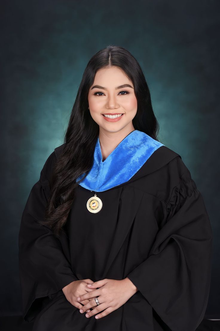 a woman in graduation gown posing for a photo