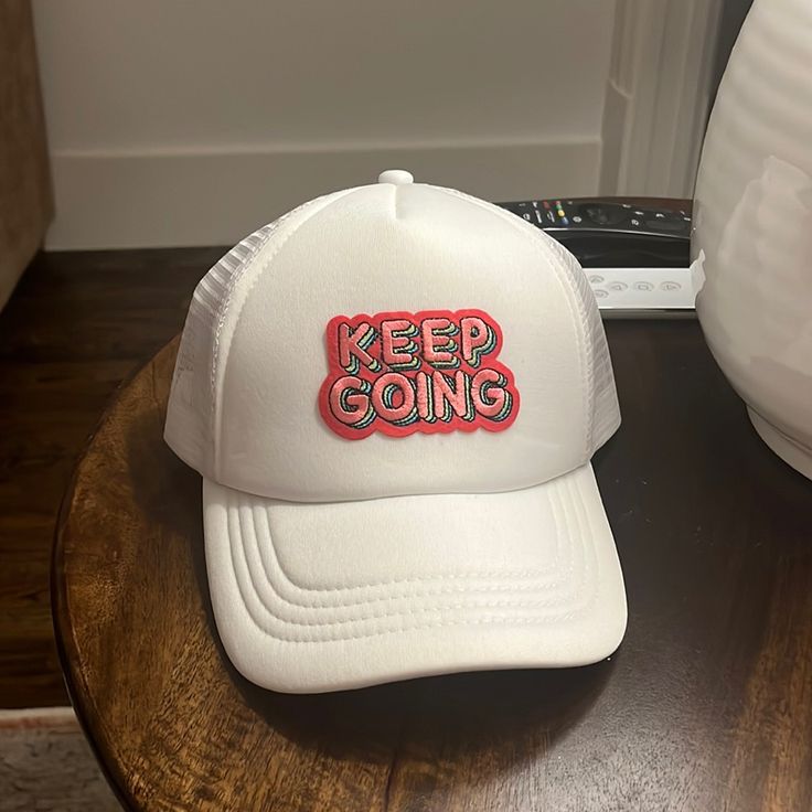 a white hat sitting on top of a wooden table