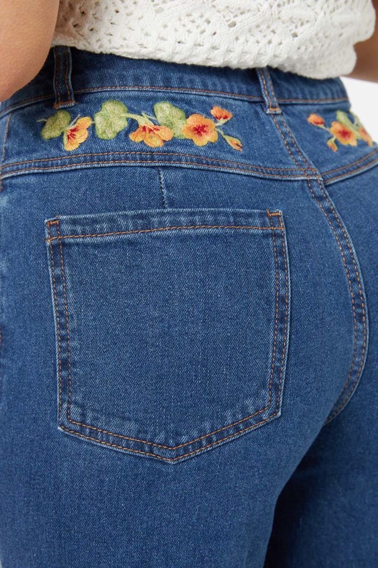 Floral embroidered straight leg jean, featuring gorgeous hand painted nasturtium flowers - Nasturtim mbroidery along front pockets and back yoke- high waisted style- relaxed fit through the leg- front fly with button closure- curved front pockets- patch pockets on back - comfortable cotton elastane denim- available in mid denim Product Code: PGFY272 Hand Embroidered Clothes, Denim Painting, Jean Patches, Painting Jeans, Nasturtium Flowers, Womens Matching Sets, Denim Embroidery, Patch Jeans, Sewing Clothing