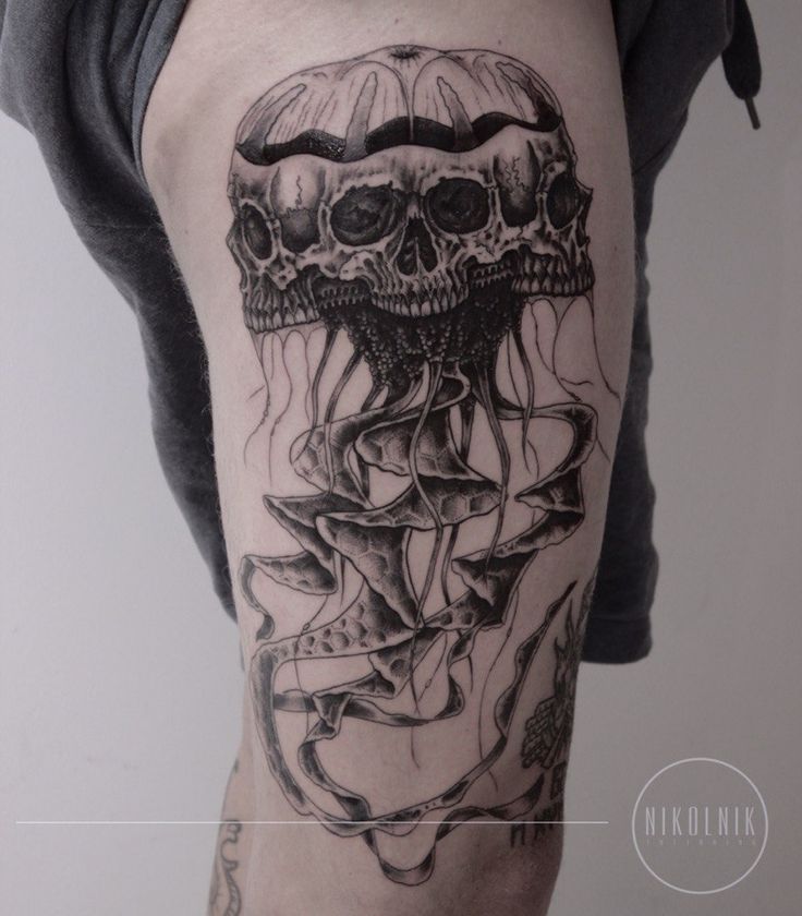 a man's leg with a tattoo on it that has an image of a jellyfish