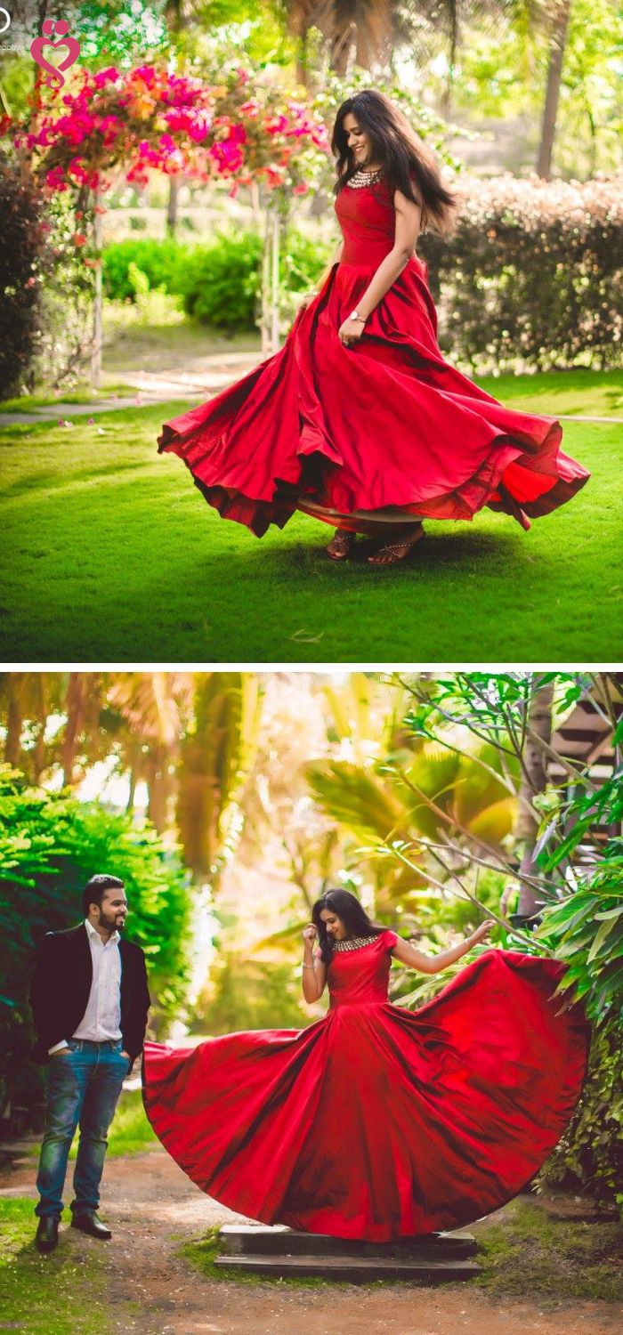 a man and woman in red dresses are dancing together on the grass with trees behind them