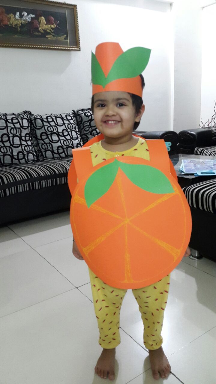 a young boy wearing an orange costume