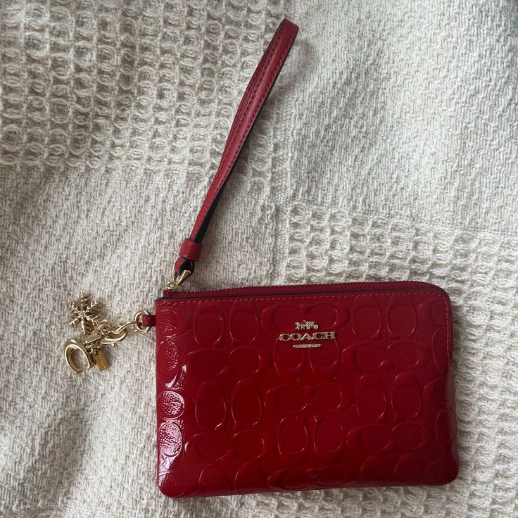 Never Used, Wristlet With Charms Red Pouch Wallets With Wrist Strap, Red Wristlet Clutch With Removable Pouch, Red Clutch Wristlet With Removable Pouch, Coach Red Clutch With Removable Pouch, Red Coach Clutch For Gift, Red Coach Clutch As A Gift, Elegant Red Wristlet With Zipper Pouch, Coach Red Wristlet With Zipper Pouch, Red Coach Rectangular Wristlet