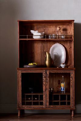 a wooden cabinet with plates and bowls on it