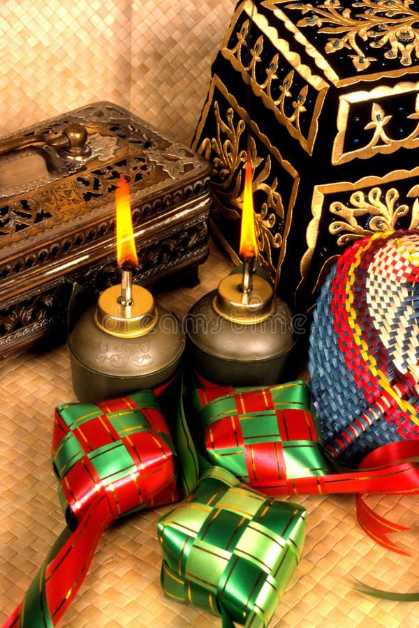 an assortment of christmas presents and candles on a table with a decorative box in the background