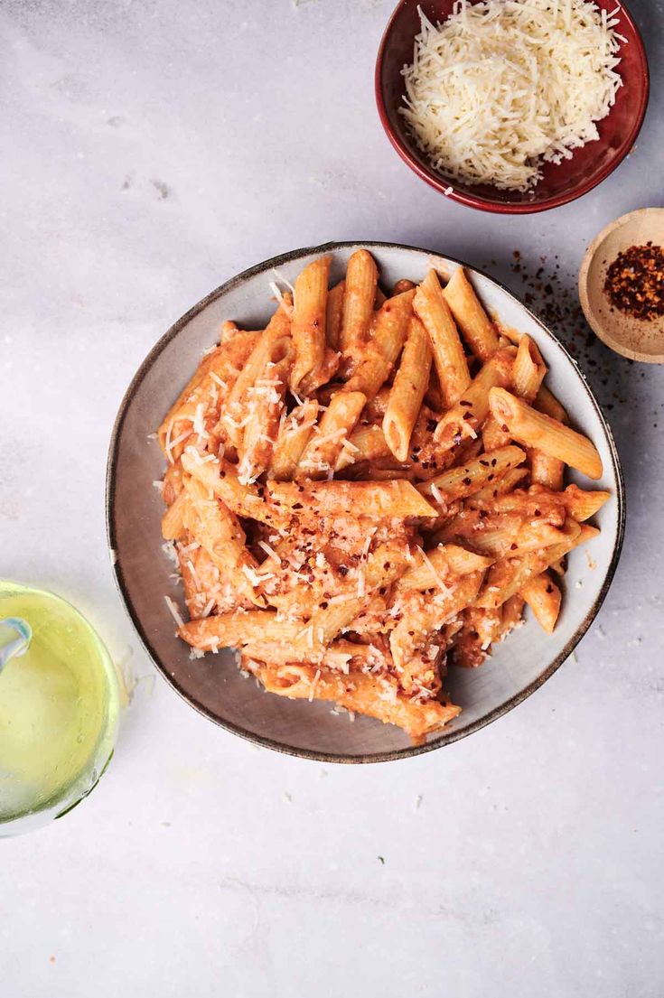 some food is on a plate with grated parmesan cheese next to it