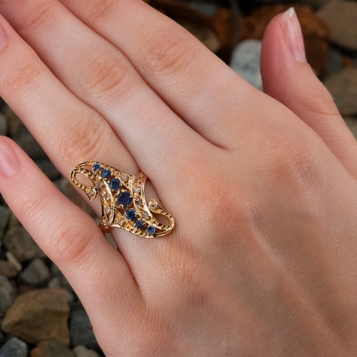 This pretty antique ring features sapphires and diamonds and is crafted of 10k yellow gold. The ring has middle eastern stamps. Some of the sapphires have chips/abrasions and the center sapphire shows some damage but appears stable. This ring is currently a size 8.75. Antique Multi-stone Gold Diamond Ring, Victorian Sapphire Ring With 17 Jewels In 14k Gold, Heirloom Yellow Gold Multi-stone Sapphire Ring, Victorian Gold Sapphire Ring With Diamond, Gold Victorian Sapphire Ring, Victorian Sapphire Ring With Diamond In Gold, Antique Gold Sapphire Ring Stamped 14k, Heirloom Gold Sapphire Diamond Ring, Collectible Yellow Gold Sapphire Ring With Diamonds