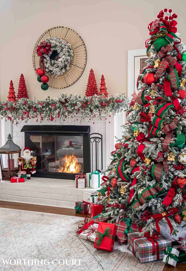 a decorated christmas tree in front of a fireplace