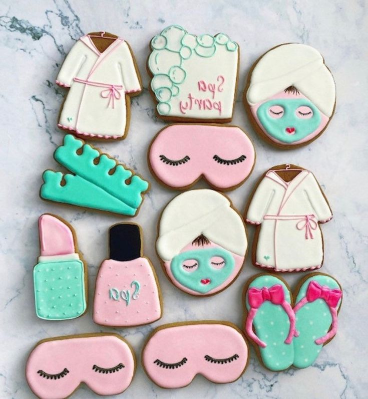 decorated cookies are arranged in the shape of women's clothing and shoes, with words on them