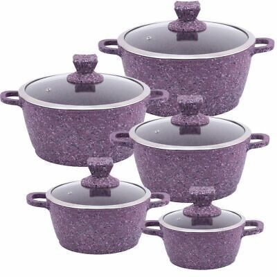 purple speckled pots with lids and handles are stacked on top of eachother