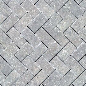 a close up view of a gray brick sidewalk with white and black lines on it