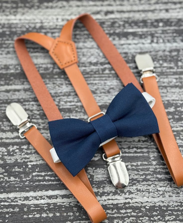 Classic Adjustable Suit Accessories For Party, Elegant Suspenders For Party Suit Accessories, Fitted Belts And Suspenders With Bow For Party, Elegant Fitted Belts And Suspenders With Bow, Classic Suspenders For Suit And Tie At Party, Dapper Summer Party Suit And Tie Accessories, Elegant Adjustable Bow Tie For Groom, Classic Adjustable Belts And Suspenders For Party, Elegant Adjustable Belts And Suspenders For Wedding