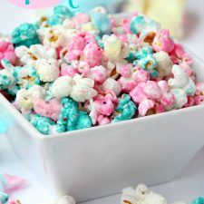 a bowl filled with pink, blue and white popcorn