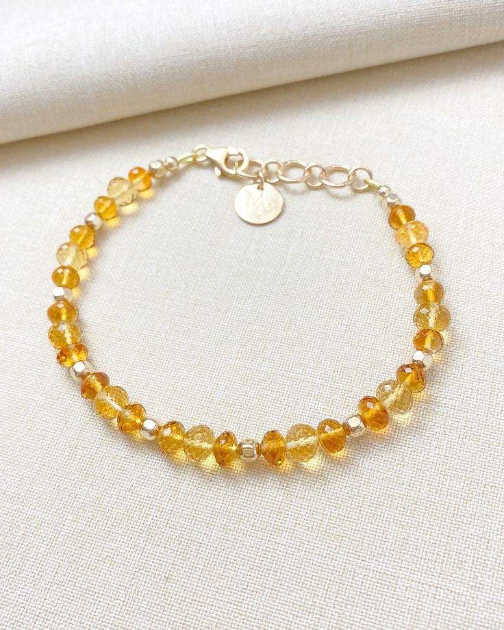 The enchanting combination of sunny yellow and rich amber-hued citrine creates this beautiful gemstone bracelet. This elegant beaded piece is finished with luminous 14k gold-filled components. November's birthstone is nothing less than captivating. Bracelet length: 7.25 inches plus 1-inch extender Materials: 4-6 mm citrine faceted beads, 14 k gold-filled components Elegant Gold Citrine Crystal Bracelet, Adjustable Citrine Yellow Gold Jewelry, Adjustable Yellow Gold Citrine Jewelry, 14k Gold-filled Gemstone Bracelets, Elegant Amber Beaded Bracelets With Natural Stones, 14k Gold Filled Gemstone Bracelets, Gold Gemstone Bracelet In 14k Gold Filled, Elegant Amber Beaded Bracelets, Adjustable Gold Citrine Crystal Bracelet